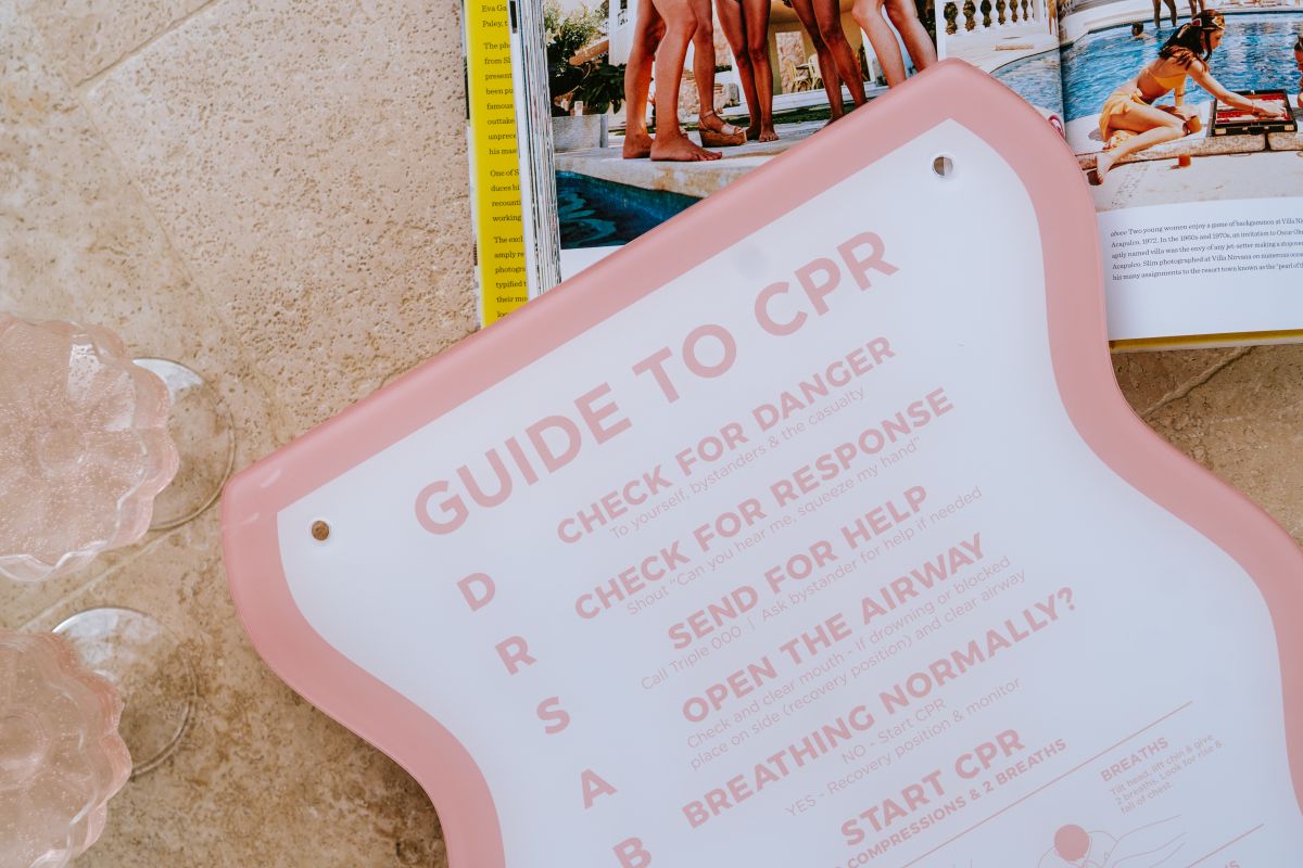 The Wave CPR Pool Sign Pink on ground close up - Palm Springs Beach Abode