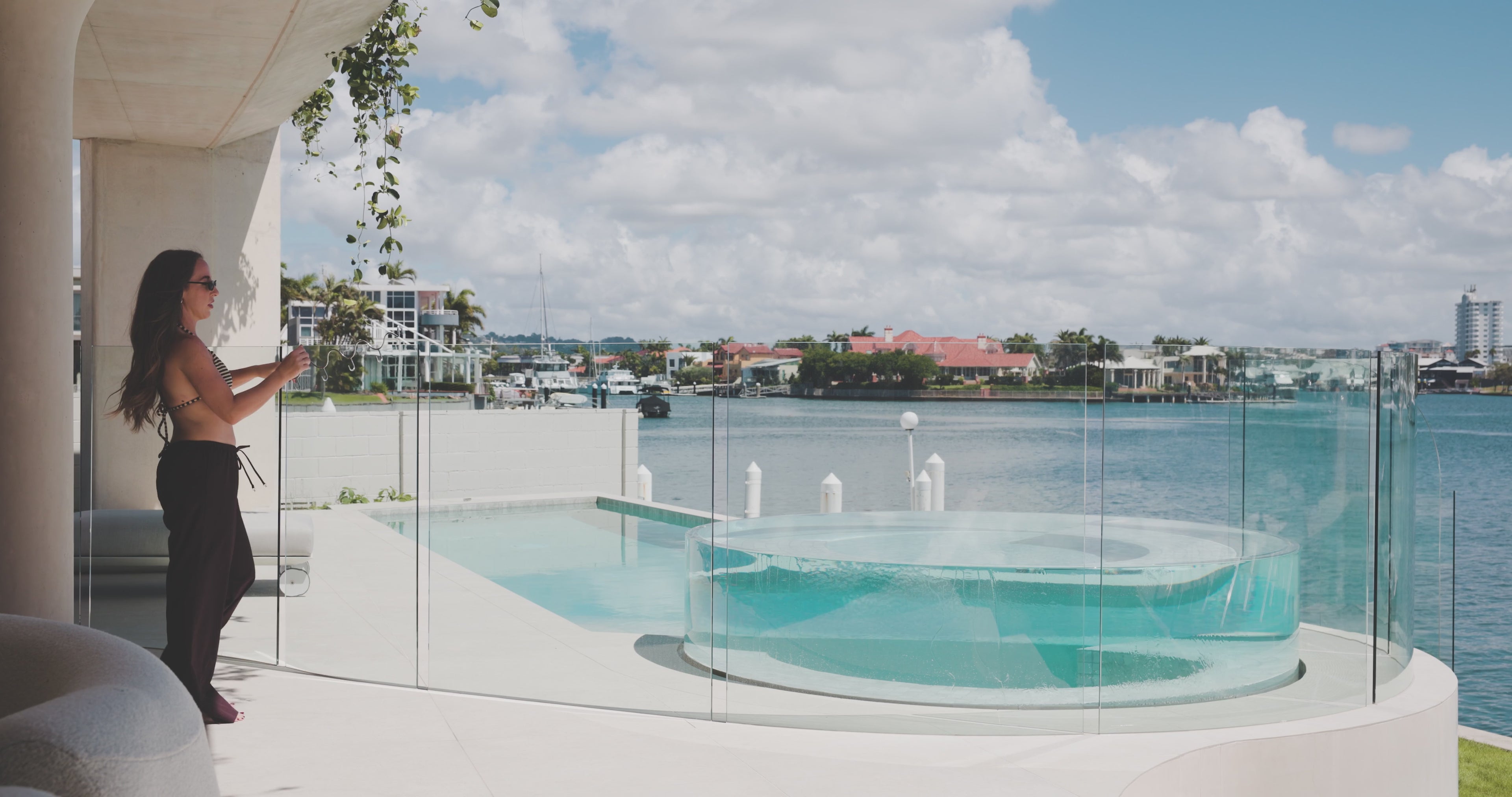 Load video: Riviera poolside hook being placed over a glass pool fence and used to hang a towel